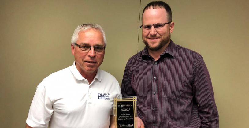 jack wolf receiving years of service plaque from trent schaaf