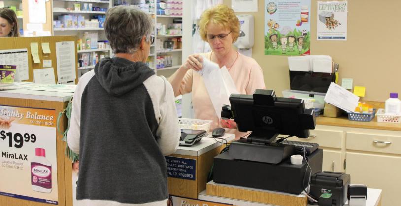pharmacy staff with customer