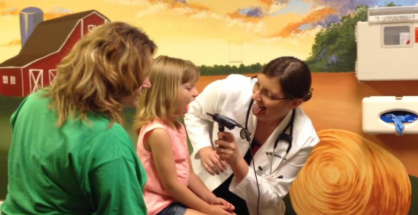 doctor with child patient and mother