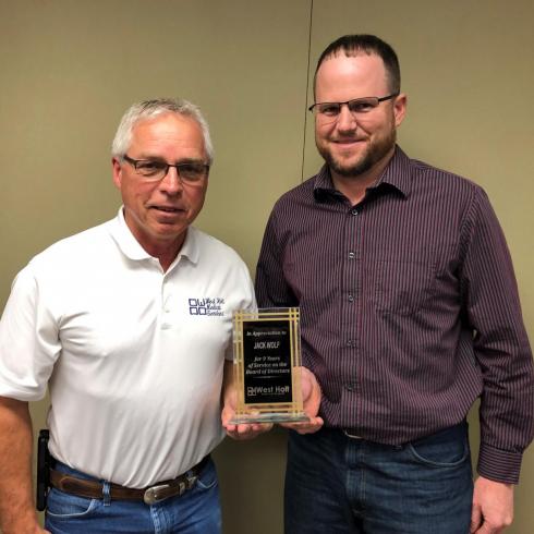 jack wolf receiving years of service plaque from trent schaaf