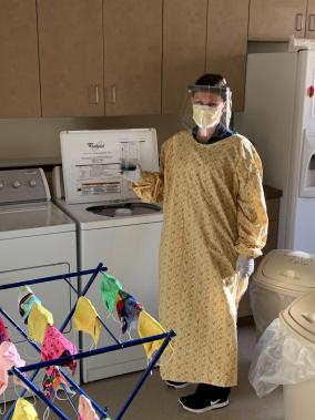 staff member laundering donated protective equipment