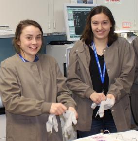 students with lab coats and gloves